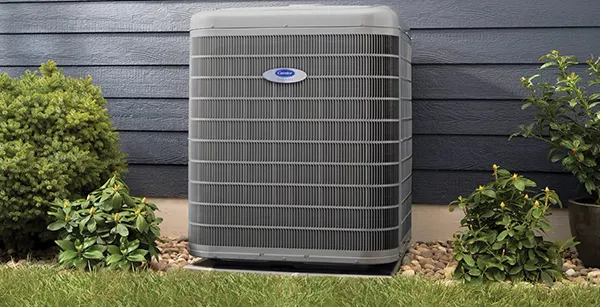 Outdoor heat pump unit installed beside a house for efficient heating and cooling